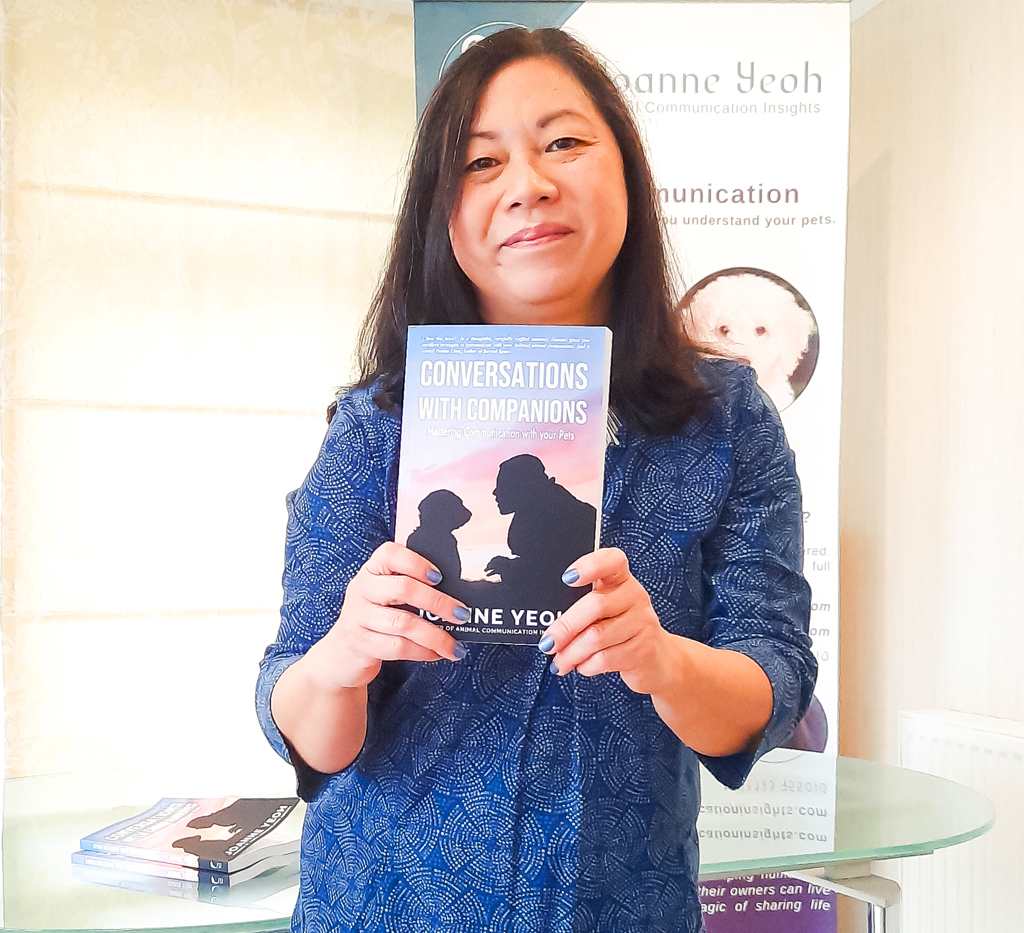 Joanne holding a copy of her book Conversations with Companions